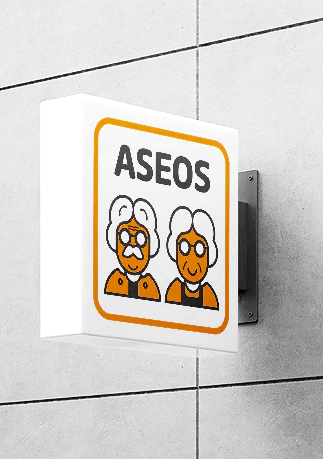 Cartel de aseos con dos abuelos